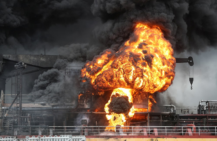 Fire from a vessel is seen at a port in Ulsan, South Korea, September 28, 2019.