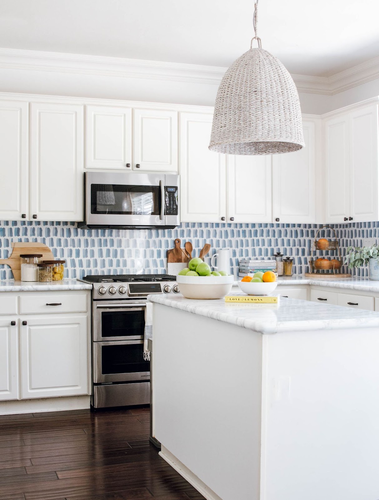 Paint or wallpaper over tile backsplash for added depth