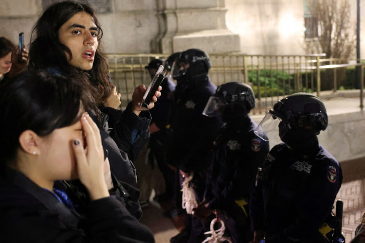 Students react as police stand guard at Columbia University ahead of a crackdown, in New York, the US, April 30 2024. Picture: REUTERS/CAITLIN OCHS