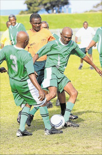 FULL STEAM AHEAD: Lunga Bukashe of Buffalo City Metro is pursued by an unnamed Alfred Nzo District Municipality opponent while his colleague offers support at the Annual Golden Games at Jan Smuts Stadium, East London, yesterday Picture: SINO MAJANGAZA