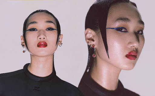 Model Erin Shin in blue eyeliner and slicked back black hair staring at the camera.