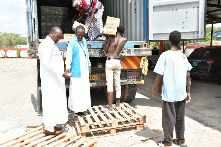 workers offloading the consignment in Garissa that was donated by UNHCR on Saturday.