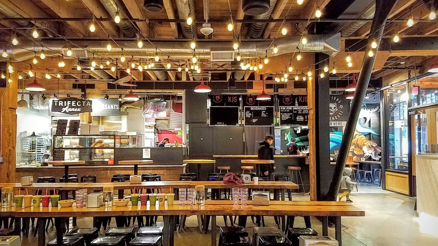 The central communal seating area inside Pine Street Market, a food hall in downtown Portland with nine vendors