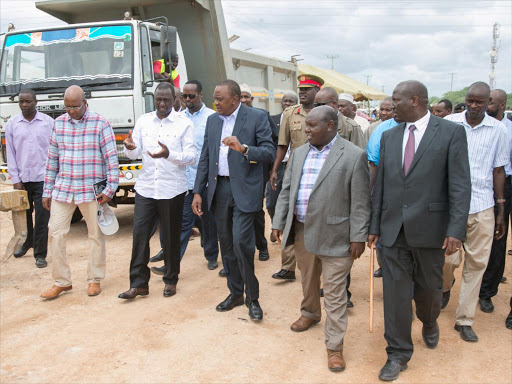 Industry PS Adan Mohammed, Deputy President William Ruto, President Uhuru Kenyatta and Transport PS John Mosonik in Mandera town yesterday /PSCU