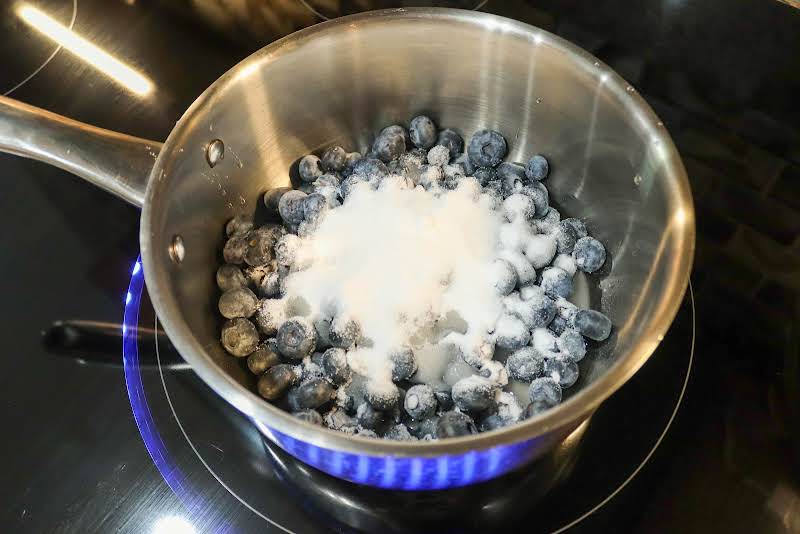 Blueberries, Water, And Sugar In A Saucepan.