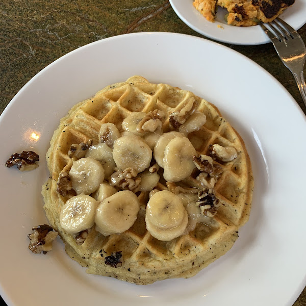 Belgian waffle Buttermilk Waffle with Bananas, Walnuts and Butter with a side of Maple Syrup