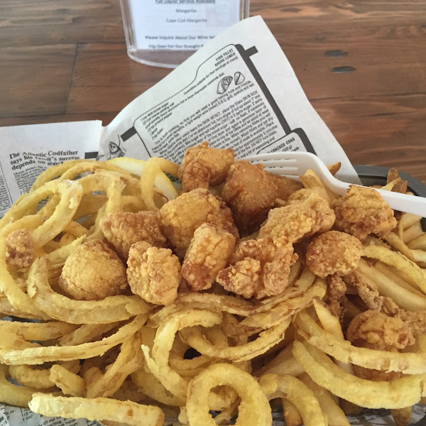 Fried scallops with onion rings and fries.