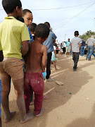 Children at an informal settlement in Bredasdorp situated next to the local tip wait in line for food. The lockdown has affected residents living here the most, and many are foreign nationals who reside in South Africa illegally making it difficult to qualify for government relief.