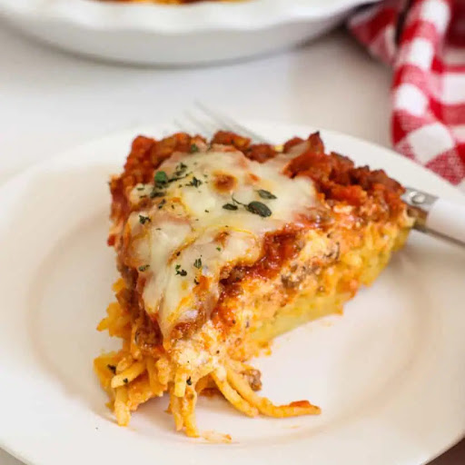 Try this quick and easy classic spaghetti pie with meat sauce, mozzarella, and ricotta cheese. It is a family favorite that even the pickiest eaters enjoy!
