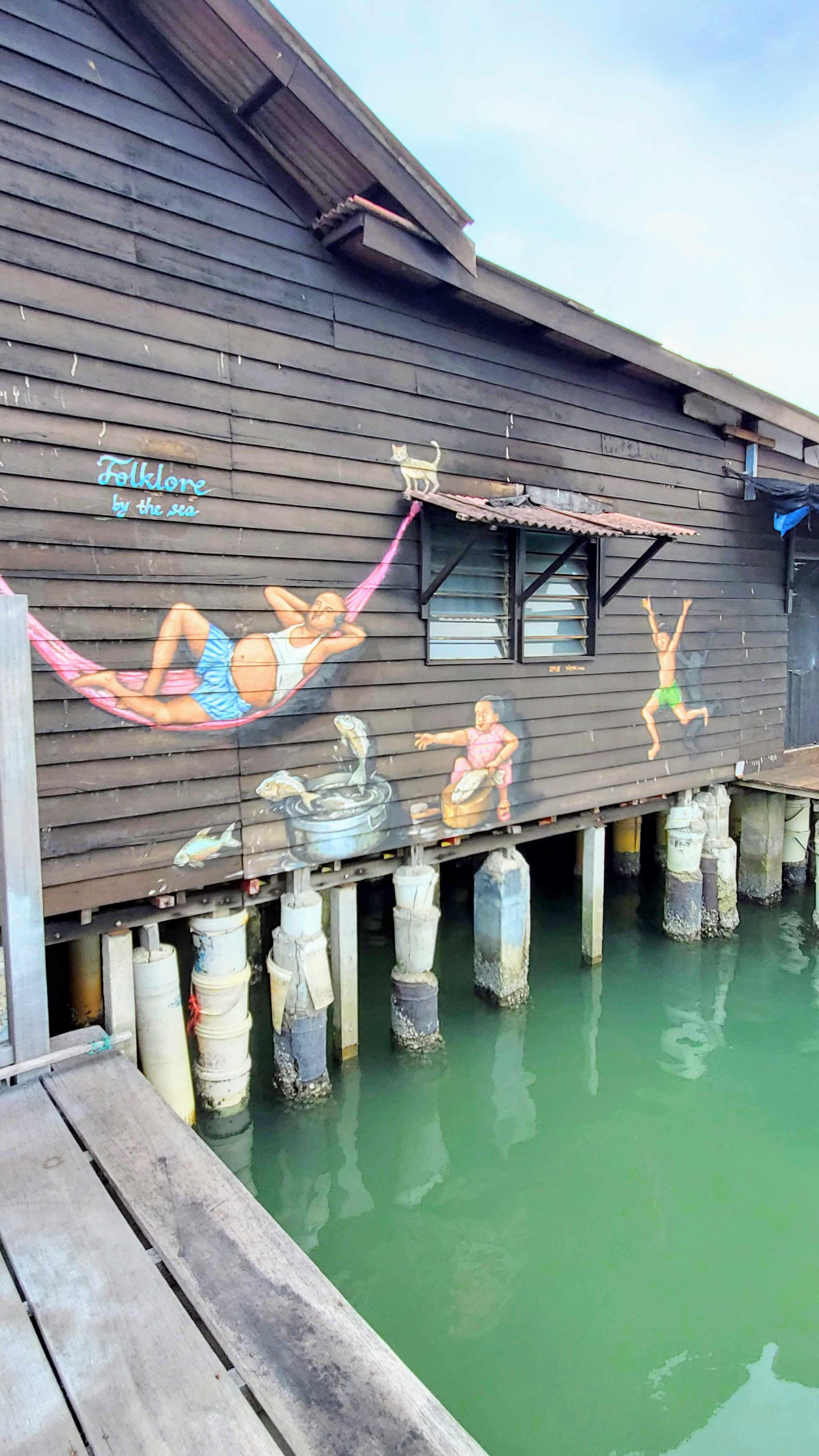 Tips on visiting George Town Street Art: Folklore by the Sea was painted on a wooden house at Chew Jetty in Weld Quay, Penang, to tell stories of life during the early days at the clan jetties