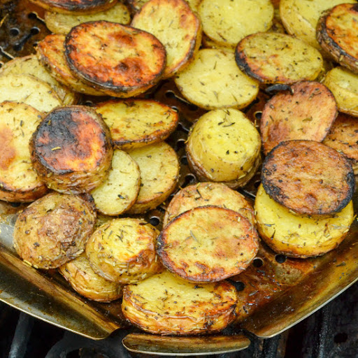 Easy and tasty Grilled Potatoes with herbs are cooked in a grill basket or aluminum foil right on top of your charcoal or gas grill.  They are the perfect side for all your summer grilling and barbecue recipes.