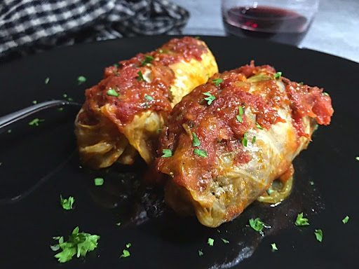 Two delicious cabbage rolls stuffed with beef and hot Italian sausage in a gorgeous well-seasoned tomato sauce.