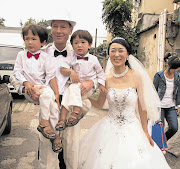 HAPPY DAY: Sean Davison with his new bride Raine Pan and sons Flynn, 4, and Finnian, 2 Picture: CAROL COETZEE