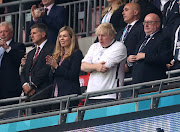 Britain's Prime Minister Boris Johnson with his wife Carrie Johnson in the stands before the final. 