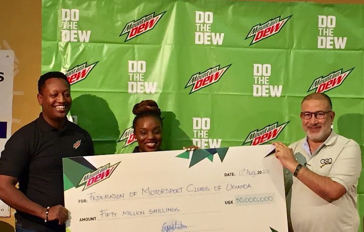 John Kazoora, Grace Namutebi the brand manager Mountain Dew handed over the cheque to Dipu Ruparelia the President FMU