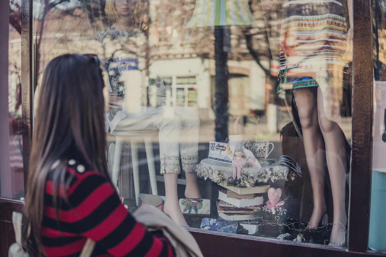 Woman looking through shop window