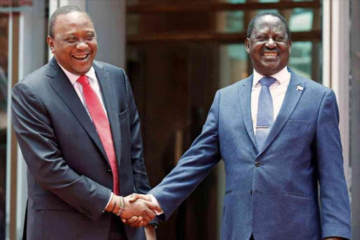 President Uhuru Kenyatta greets opposition leader Raila Odinga after addressing a news conference at the Harambee House office in Nairobi on March 9, 2018.