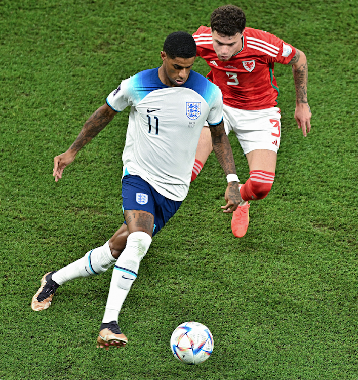 Marcus Rashford (L) of England vies for the ball with Neco Williams of Wales during a 2022 Fifa World Cup Group B match at the Ahmad Bin Ali Stadium in Al Rayyan, Qatar November 29