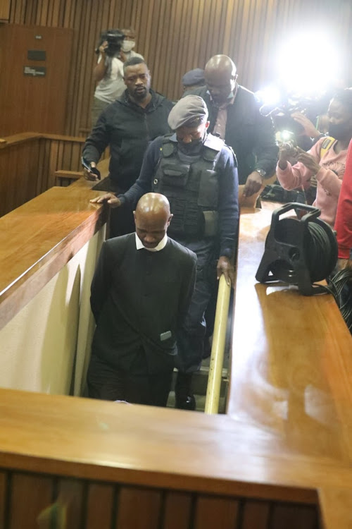 Advocate Malesela Teffo is led to the holding cells in the Pretoria high court on Thursday. Chief justice Raymond Zondo said the conduct of the police in effecting the arrest inside a courtroom was an assault on the dignity of the court and the judiciary.