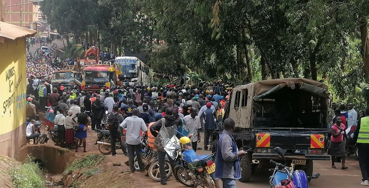 A crowd mill at the scene where a Modern Coast bus lost control and veered into the river in Kisii on Wednesday, December 28, 2022.