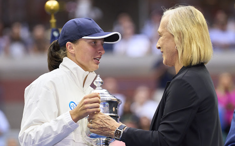 Iga Swiatek of Poland is presented the championship trophy by Martina Navratilova after defeating Ons Jabeur of Tunisia in the final of the 2022 US Open at Billie Jean King National Tennis Centre in New York City on September 10 2022.