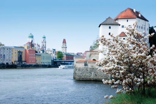 Spring blossoms bloom along the riverbank during the cruising season in Passau, Germany.