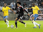 HEMMED IN: Issa Sarr of Orlando Pirates on the attack during the Absa Premiership match against Mamelodi Sundowns at Orlando Stadium, Soweto, last night. Pirates produced a better effort but could not get a winner