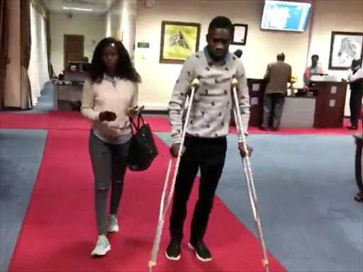 Bobi Wine walks on crutches before his departure at Entebbe International Airport, in Entebbe, Uganda, August 31, 2018 in this still image taken from a social media video on September 1, 2018. /REUTERS