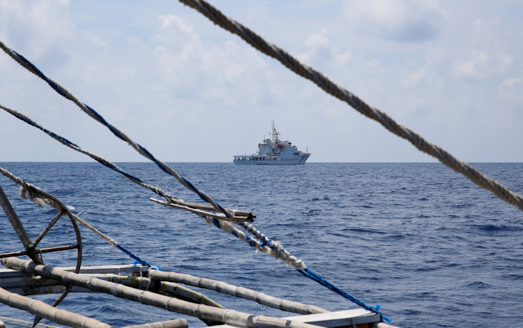 A China Coast Guard ship is seen from a Philippine fishing boat at the disputed Scarborough Shoal in this April 6 2017 file photo. Picture: ERIK DE CASTRO/REUTERS