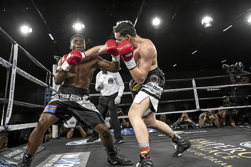 Rowan Campbell connects with an overarm right en route to stopping Congolese Patrick Mukala in the seventh round at Emperors Palace on Friday night.