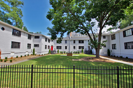 White building facades, green courtyard, black fence in this luxury apartment / penthouse for sale in Atlanta ($285,000)