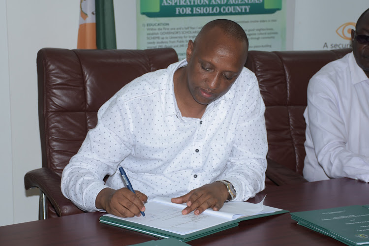 Isiolo Governor Abdi Hassan Guyo signs performance contracts of his cabient and chief officers in Mombasa on September 21, 2023