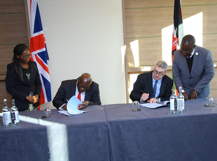 Kenya High Commissioner to the UK Manoah Esipisu and Christie NHS Foundation Trust CEO Peter Roger sign a deal on cooperation in capacity building in oncology in London