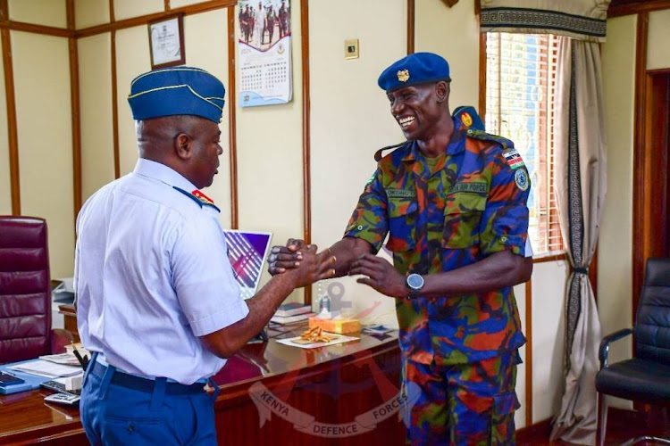 Kenya Air Force Seargent Edwin Okong'o shakes hands with Commander Kenya Air Force (KAF), Major General John Omenda.