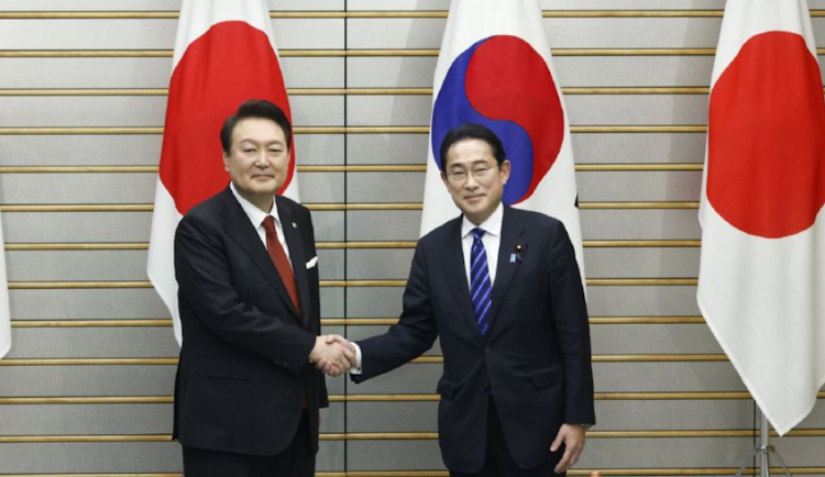 Yoon Suk Yeol, South Korea's president, left, and Fumio Kishida, Japan's prime minister, shake hands ahead of a summit meeting at the prime minister's official residence in Tokyo, Japan, on March 16 2023. Picture: KIYOSHI OTA/BLOOMBERG