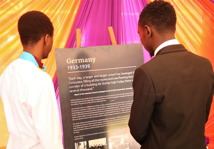 Sam Wanyoko and Zablone Adam stare at artifacts on display