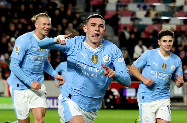 Phil Foden celebrates with teammates Erling Braut Haaland and Julian Alvarez after scoring Manchester City's second goal in their Premier League win agianst Brentford at Brentford Community Stadium in London on Monday night.