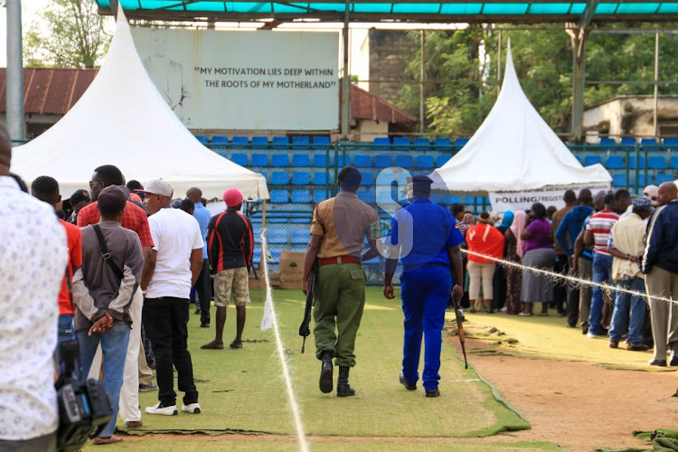 A police officers keep vigil during voting at Uwanja wa Mbuzi kongowea in Nyali constituency Mombasa county.