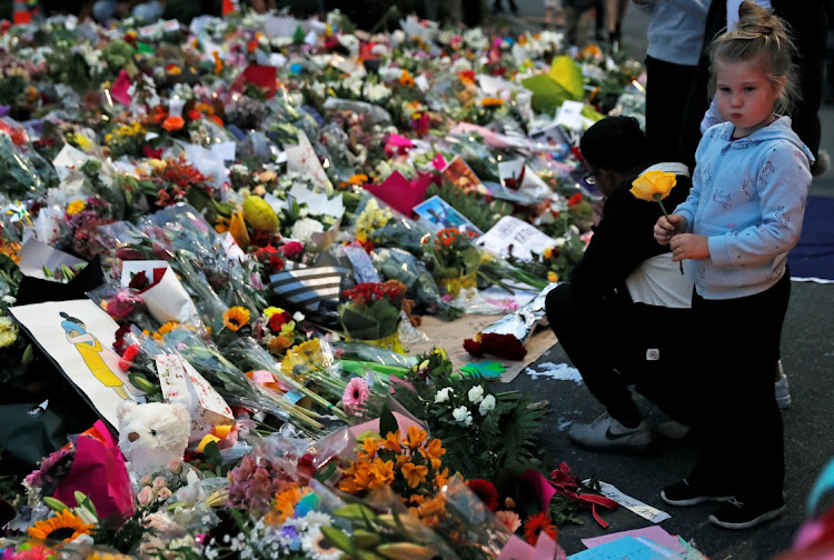 People visit a memorial site for victims in front of the Masjid al-Noor mosque in Christchurch, New Zealand, on March 18 2019. Picture: REUTERS/JORGE SILVA