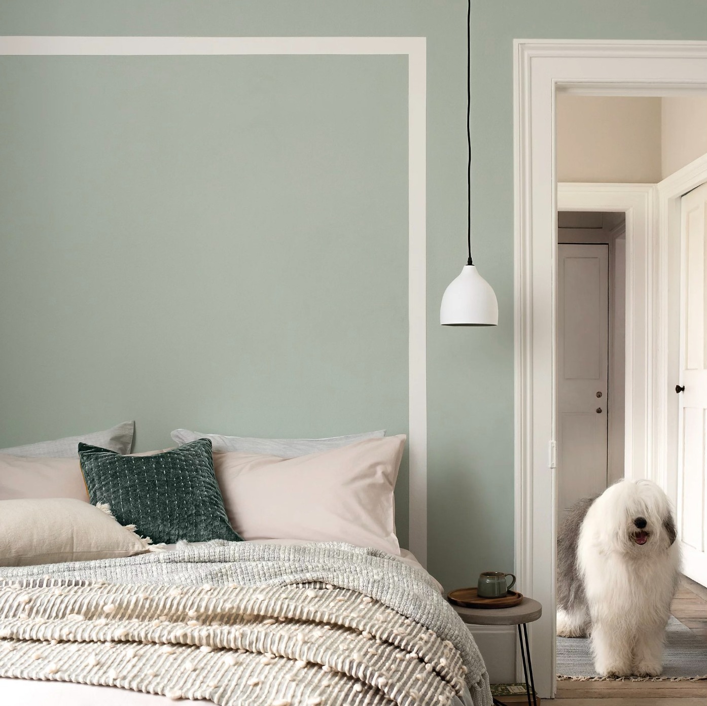 Bedroom with walls painted in sage green and cream