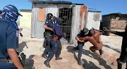 Khayelitsha resident Bulelani Qholani being dragged out of his shack naked. / SCREENGRAB