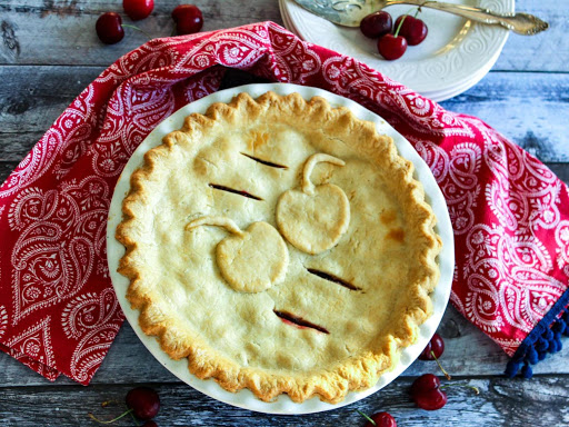 Baked cherry pie with a red napkin.