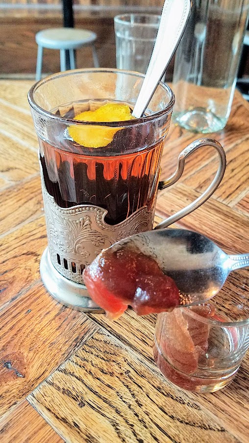 Kachinka Baba Sima's Tonic, which is a version of the hot toddy that includes a bit of tableside show of ingredients. The drink is sweetened with a caramelized cube of sugar lit on fire, a spoonful of jam that you can add to the tea or take small nibbles of as you drink the beverage. The drink is inspired from Chef Owner Bonnie Morales' grandmother's invention