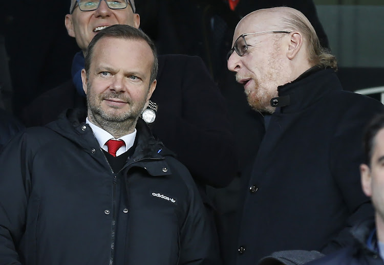 Manchester United's US co-chairman Avram Glazer (R) talks with Manchester United's executive vice-chairman Ed Woodward