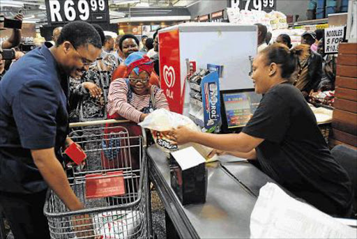 LENDING A HAND: Eastern Cape Rural Development and Agrarian Reform MEC, Mlibo Qoboshiyane helping a shopper