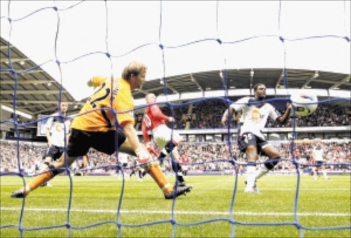 ANOTHER HAT-TRICK: Manchester United's Wayne Rooney scores his first goal against Bolton Wanderers during their Premiership match in Bolton, England, on Saturday. Photo: REUTERS