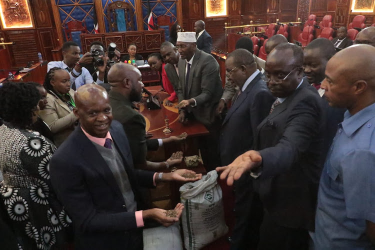 Members of the Senate agriculture committee look at the quality of the fertiliser brought during the committee meeting in Senate on April 11, 2024/