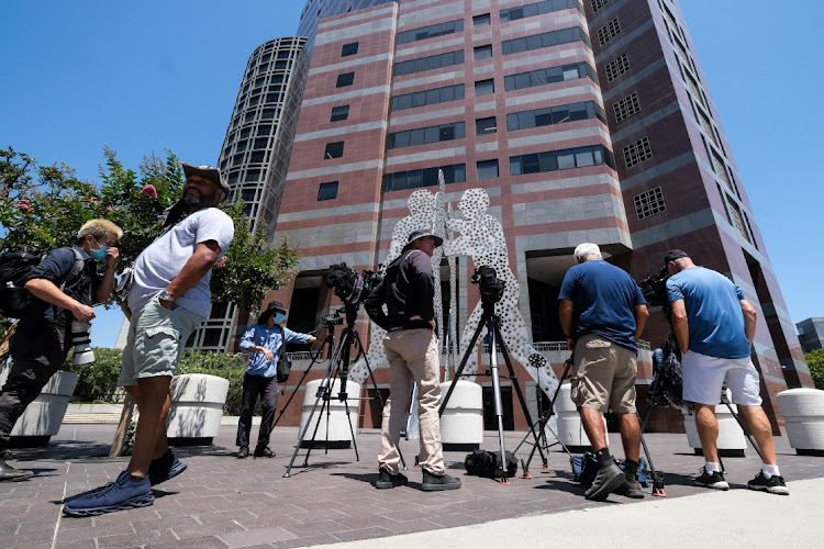 Members of the media wait outside federal court building after Thomas Barrack, a billionaire friend of Donald Trump who chaired the former president's inaugural fund, is arrested for illegally lobbying the Trump administration on behalf of the United Arab Emirates, in Los Angeles, California, US, July 20, 2021.