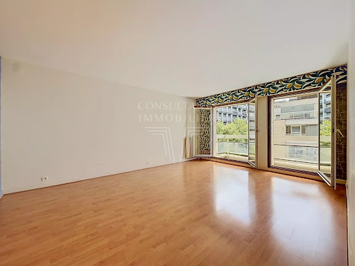 Living room with wood floor and balcony in this luxury apartment / penthouse for sale in Paris 15ème ($1,104,130 - 88 m²)