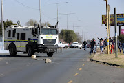 Diepkloof  hostel residents throw stones at police during a protest over water and electricity.